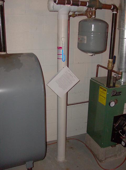 Radon mitigation pipe installed in a basement near mechanical equipment